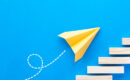 paper airplane flies up the stairs