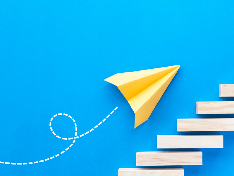 paper airplane flies up the stairs