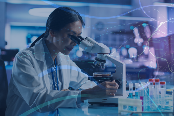 woman looking into microscope